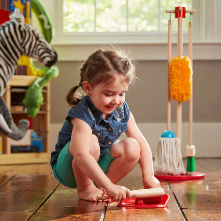 Melissa & Doug July 4th Top Toys to Encourage Independence blog post child playing with Dust Mop Sweep cleaning play set