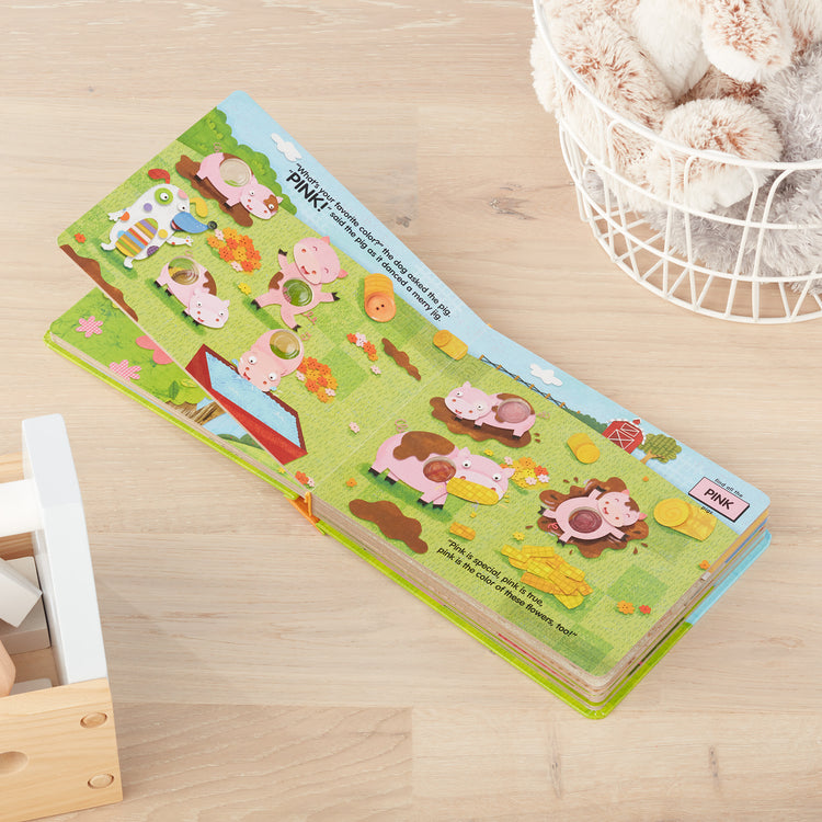 A playroom scene with The Melissa & Doug Children's Book - Poke-a-Dot: What’s Your Favorite Color (Board Book with Buttons to Pop)