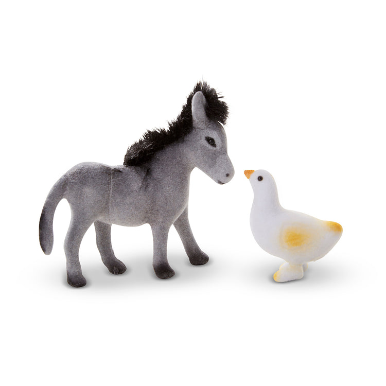 A kid playing with The Melissa & Doug Farm Friends Collectible Toy Animal Figures (10 pcs)