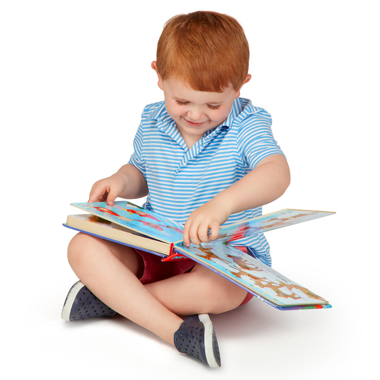 A child on white background with The Melissa & Doug Children's Book - Poke-a-Dot:The Night Before Christmas (Board Book with Buttons to Pop)