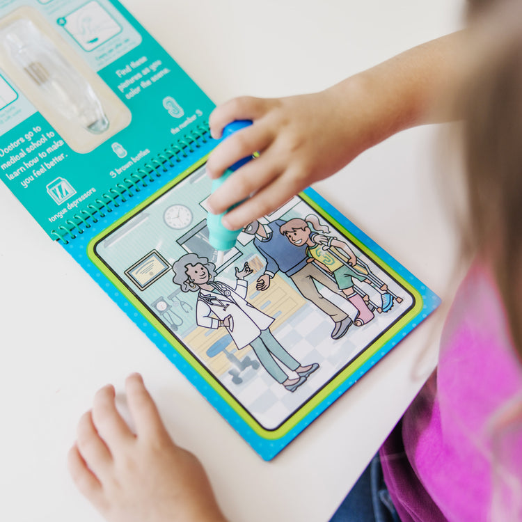 A kid playing with The Melissa & Doug On the Go Water Wow! Reusable Water-Reveal Activity Pad – Occupations