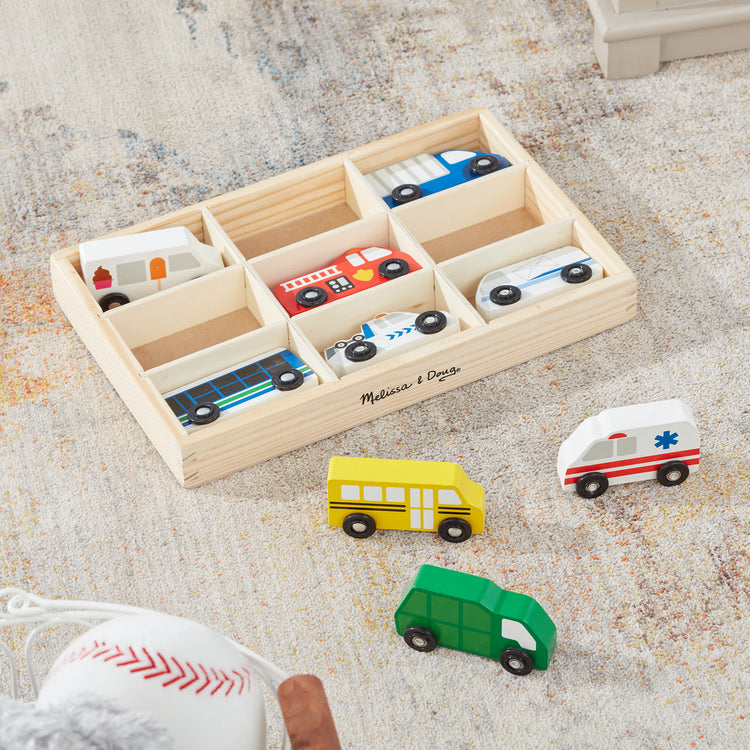 A playroom scene with The Melissa & Doug Wooden Town Vehicles Set in Wooden Tray (9 pcs)