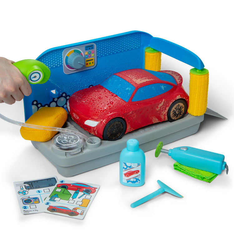 The loose pieces of The Melissa & Doug Spray & Shine Car Wash Color-Changing Water Toy Play Set Boys and Girls 3+