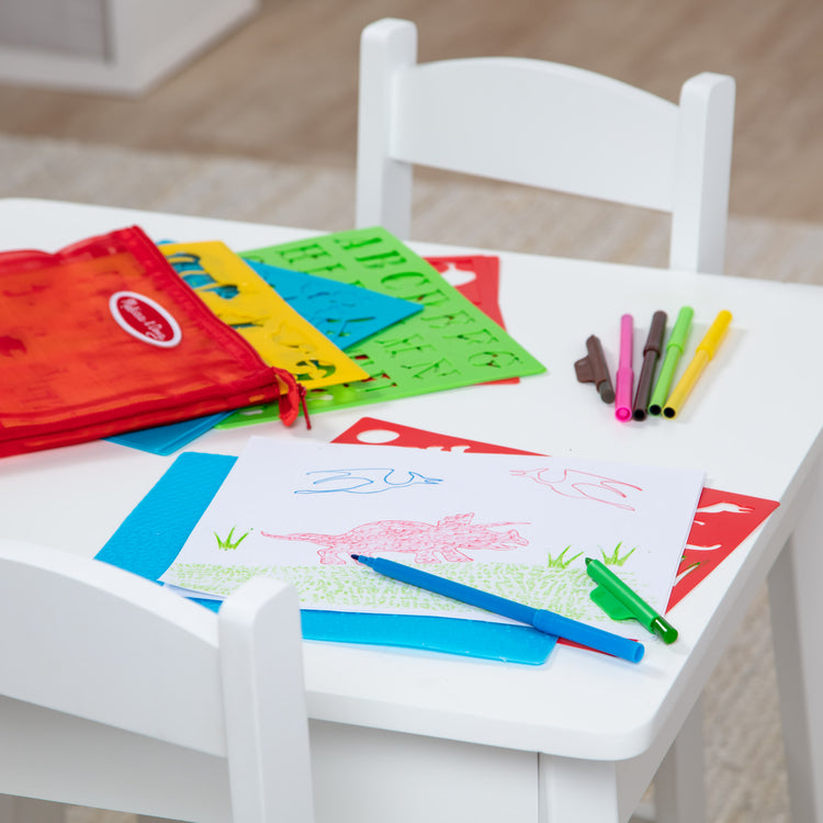 A playroom scene with The Melissa & Doug Created by Me! Stencil Art Coloring Activity Kit in Storage Pouch -- 170+ Designs, 6 Markers, 2 Crayons, Paper