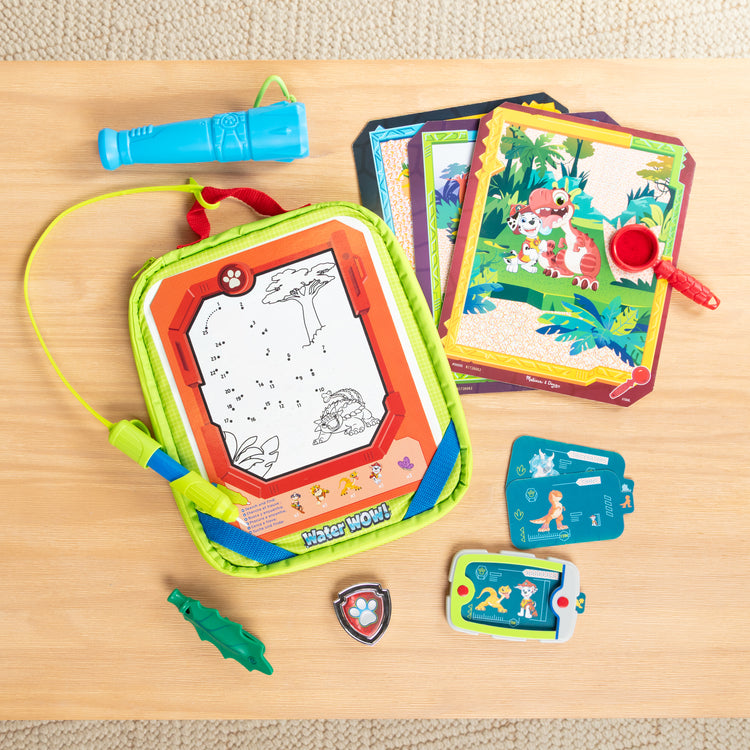 A playroom scene with The Melissa & Doug PAW Patrol Dino Adventure Water WOW! and Role Play Set in Take-Along Case - For Ages 3+