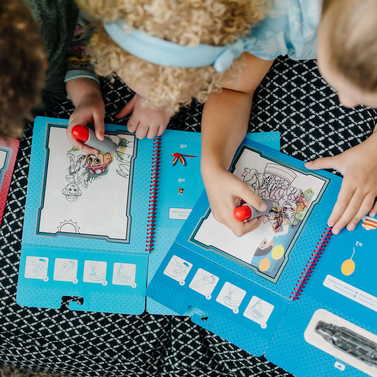 A kid playing with The Melissa & Doug PAW Patrol Water Wow! 3-Pack - Skye, Chase, Marshall Water Reveal Travel Activity Pads