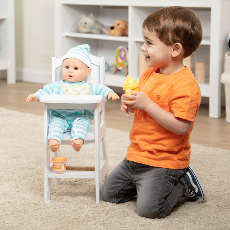 A kid playing with The Melissa & Doug Mine to Love Wooden Play High Chair for Dolls, Stuffed Animals - White (18”H x 8”W x 11”D Assembled)
