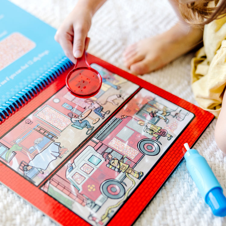 A kid playing with The Melissa & Doug On the Go Water Wow! Reusable Water-Reveal Deluxe Activity Pad – Around Town