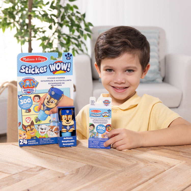 A kid playing with The Melissa & Doug Sticker WOW!™ PAW Patrol Chase Bundle: 24-Page Activity Pad, Sticker Stamper, 500 Stickers, Mini Pad, Arts and Crafts Fidget Toy Collectible Character