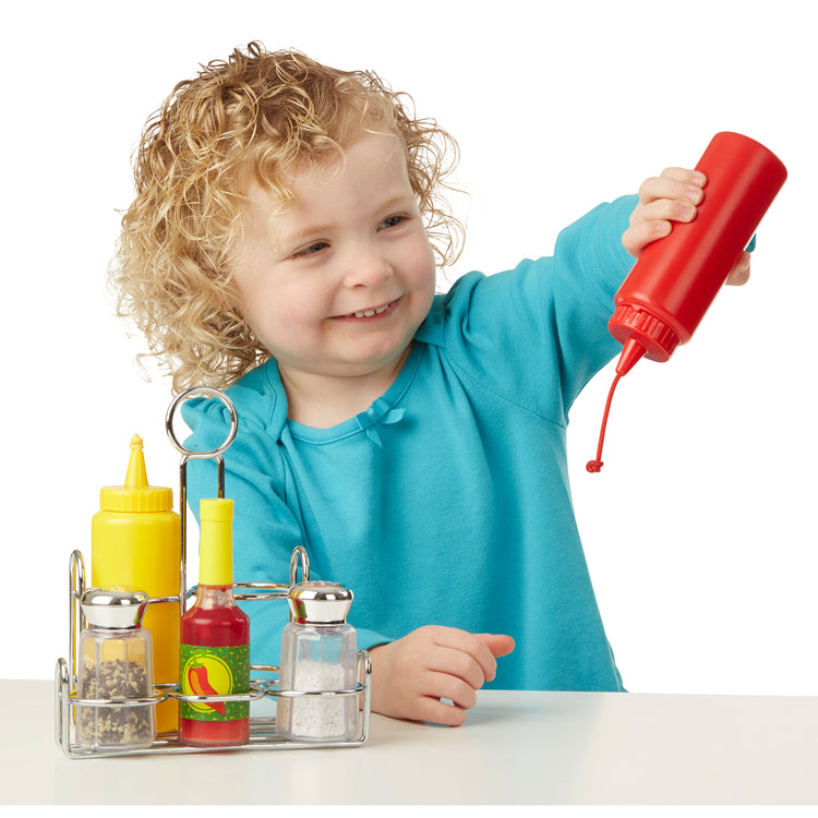 A playroom scene with The Melissa & Doug Condiments Play Set (6 pcs) - Play Food, Stainless Steel Caddy
