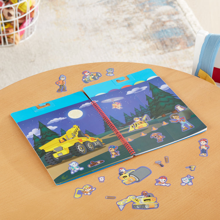 A playroom scene with The Melissa & Doug PAW Patrol Restickable Stickers Flip-Flap Pad - Ultimate Rescue (130 Reusable Stickers)