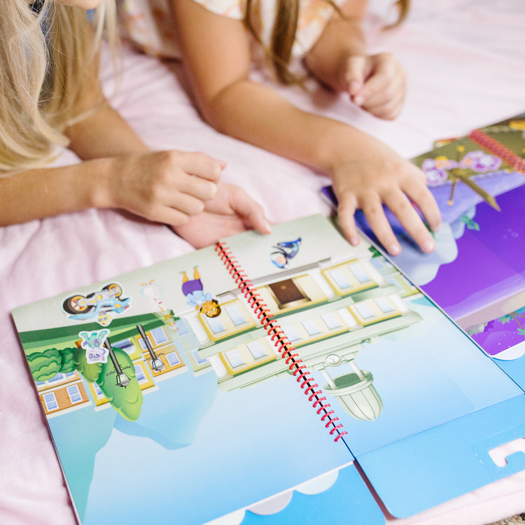 A kid playing with The Melissa & Doug PAW Patrol Restickable Stickers Flip-Flap Pad - Classic Missions (130 Reusable Stickers)