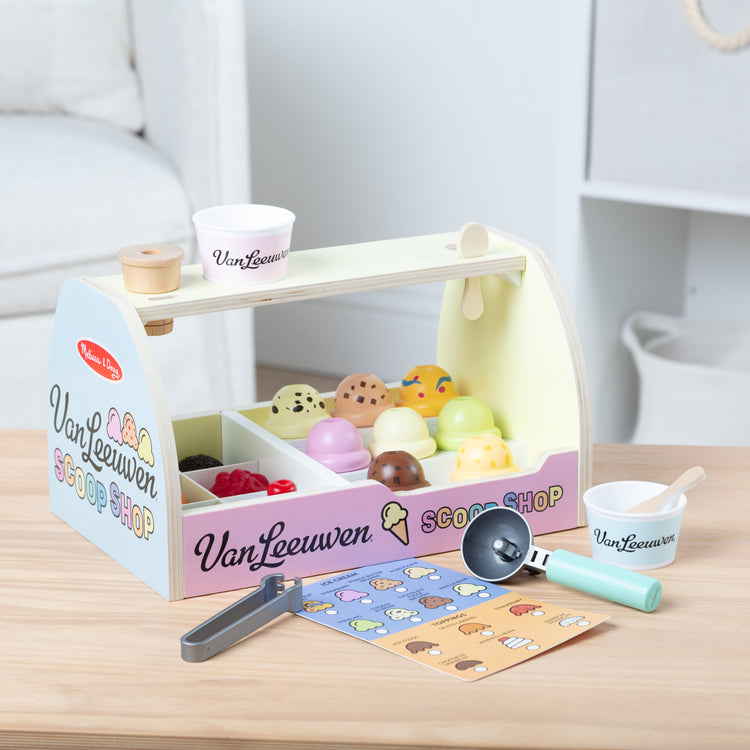 A kid playing with The Van Leeuwen Scoop Shop Ice Cream Play St