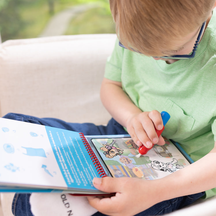 A playroom scene with The Melissa & Doug Water WOW! PAW Patrol Marshall Reusable Coloring Book with Refillable Water Pen - For Ages 3+