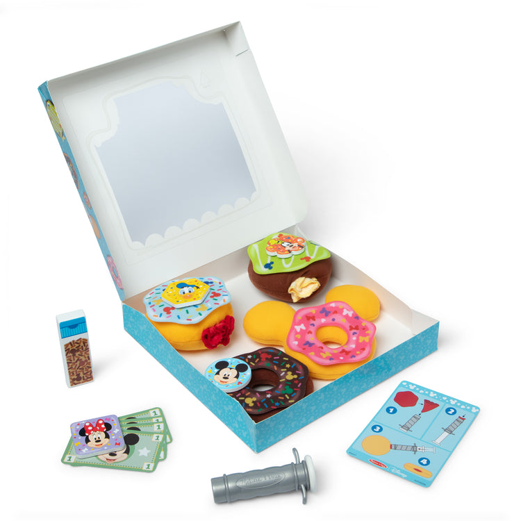 The loose pieces of The Melissa & Doug Disney Fill and Top Donut Play Set with 4 Squishy Donuts and Wooden Toppings - For Ages 3+