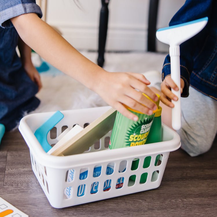A kid playing with The Deluxe Cleaning & Laundry Play Set