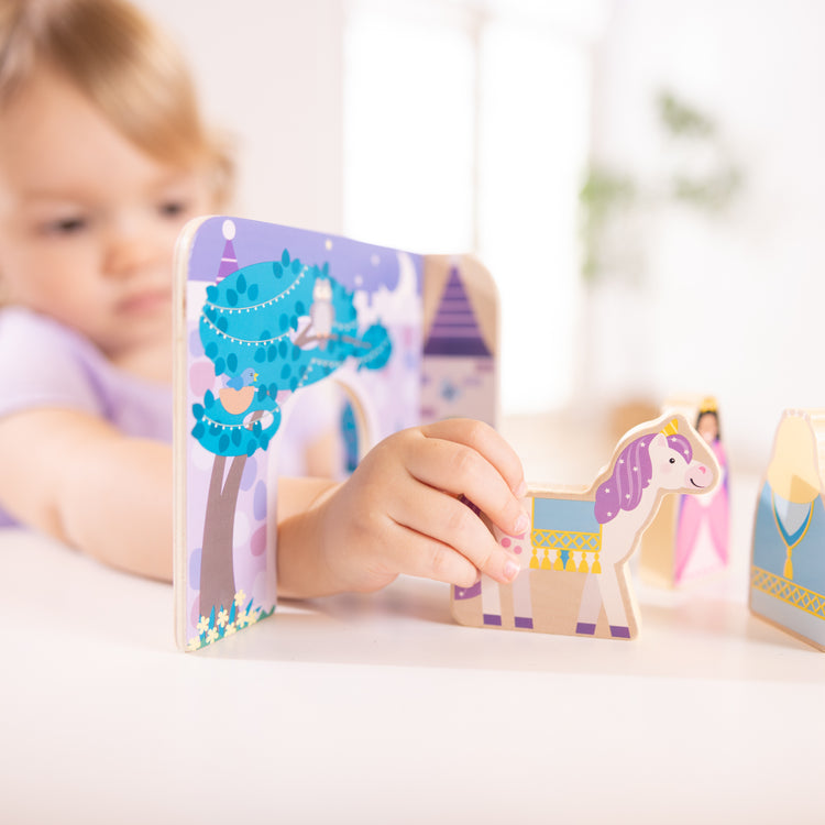 A kid playing with The Wooden Fairy Tale Play Set