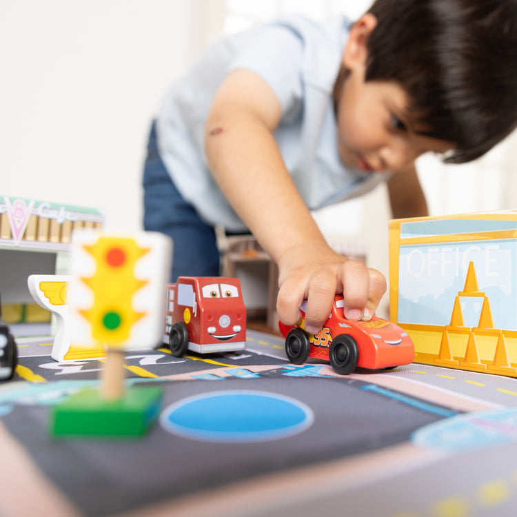 A kid playing with The Radiator Springs Nest and Stack Play Set