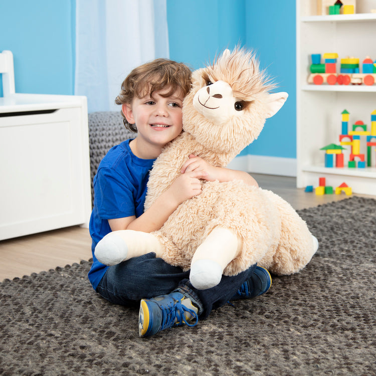 A kid playing with The Melissa & Doug Jumbo Llama Stuffed Plush Animal (26 Inches Tall)