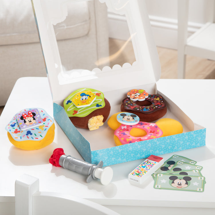 A playroom scene with The Melissa & Doug Disney Fill and Top Donut Play Set with 4 Squishy Donuts and Wooden Toppings - For Ages 3+