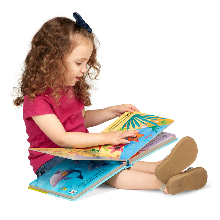 A child on white background with The Melissa & Doug Children's Book - Poke-a-Dot: Who’s in the Ocean (Board Book with Buttons to Pop)