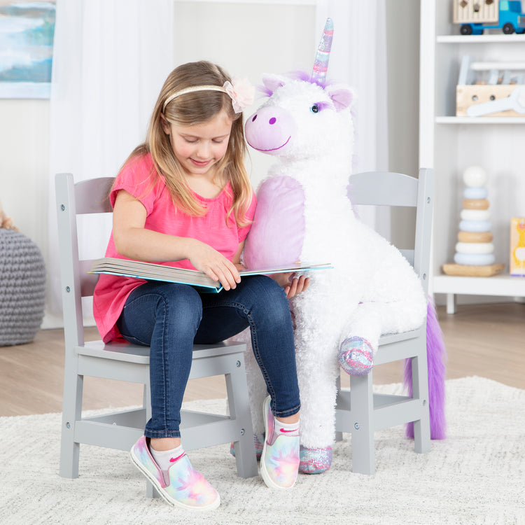 A child on white background with The Melissa & Doug Kids Furniture Wooden Chair Pair - Gray