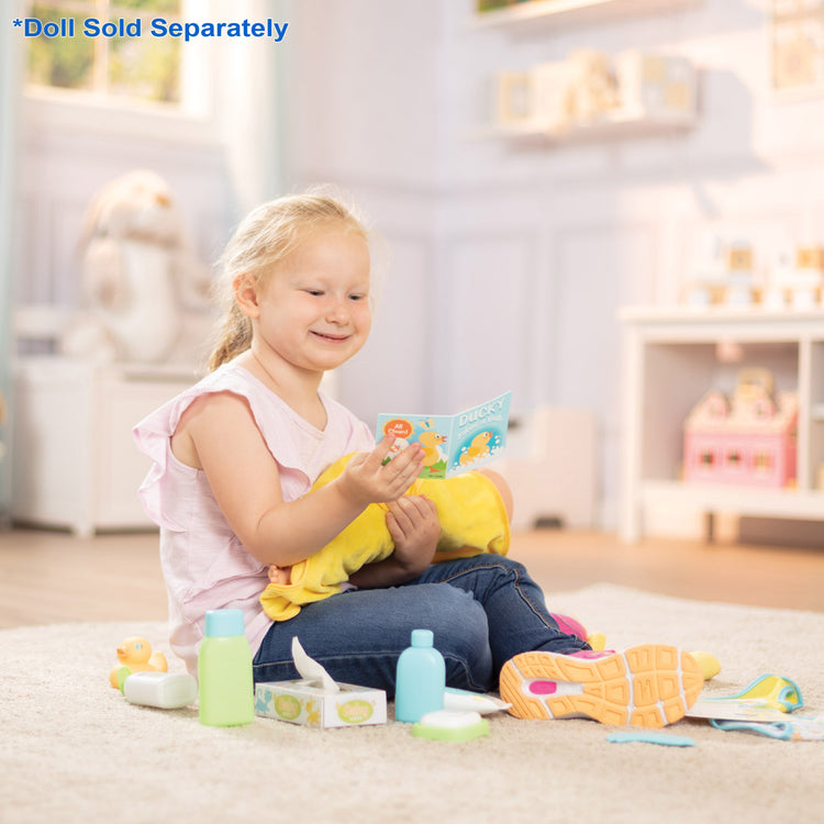 A kid playing with The Melissa & Doug Mine to Love Changing & Bathtime Play Set for Dolls – Diapers, Pretend Shampoo,Wipes, Towel,  More (19 pcs)