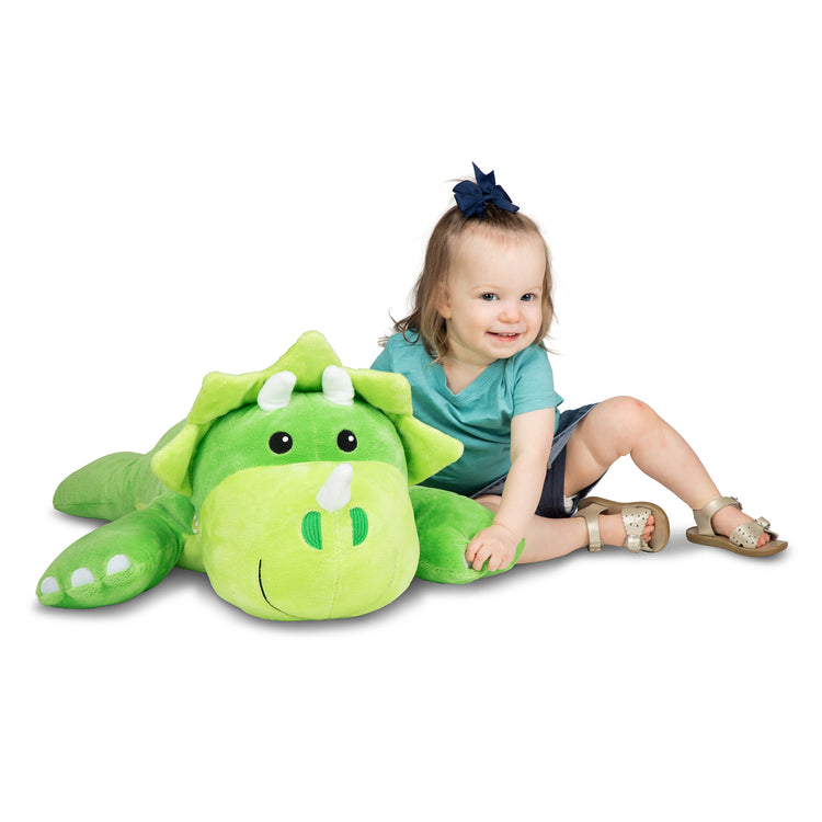A child on white background with The Melissa & Doug Cuddle Dinosaur Jumbo Plush Stuffed Animal with Activity Card