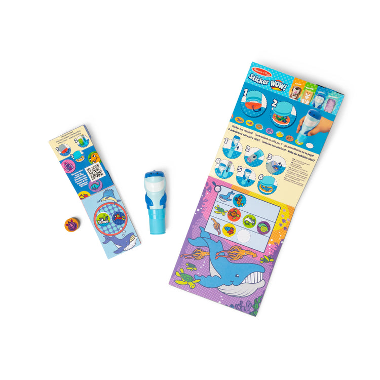 The loose pieces of The Melissa & Doug Sticker WOW!™ Shark Bundle: 24-Page Activity Pad, Sticker Stamper, 500 Stickers, Mini Pad, Arts and Crafts Fidget Toy Collectible Character