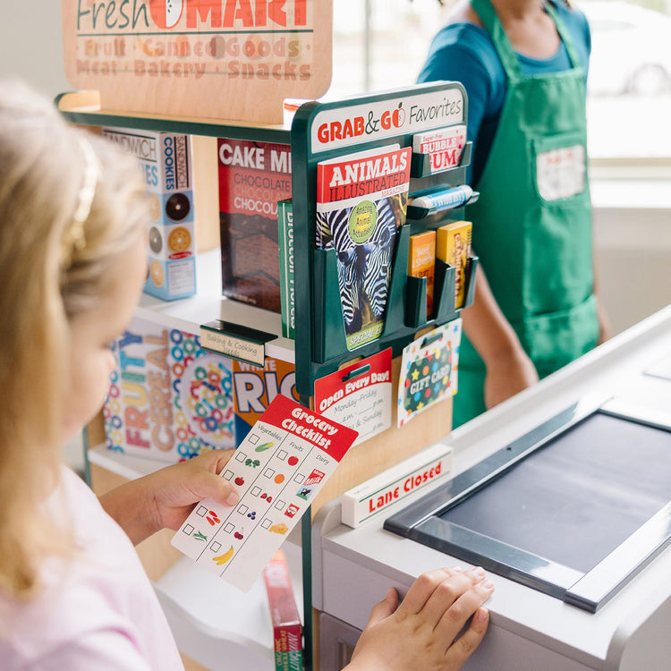 Girl with Grocery Store Toy