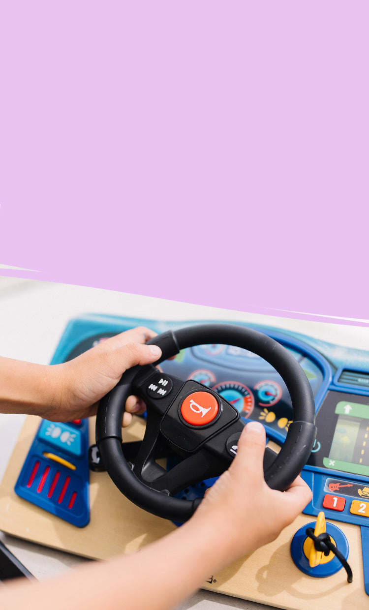 Child playing with the Vroom & Zoom Dashboard
