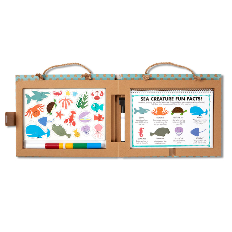 The loose pieces of The Melissa & Doug Natural Play: Play, Draw, Create Reusable Drawing & Magnet Kit – Ocean (42 Magnets, 5 Dry-Erase Markers)