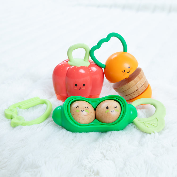 A playroom scene with The Farmers Market Veggie Rattles Trio