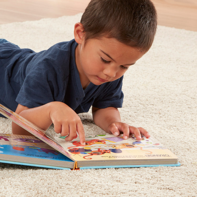 A kid playing with The Melissa & Doug Children's Book - Poke-a-Dot: What’s Your Favorite Color (Board Book with Buttons to Pop)