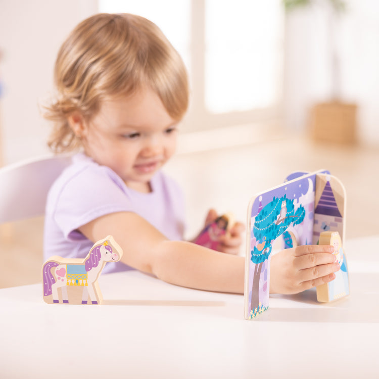 A kid playing with The Wooden Fairy Tale Play Set