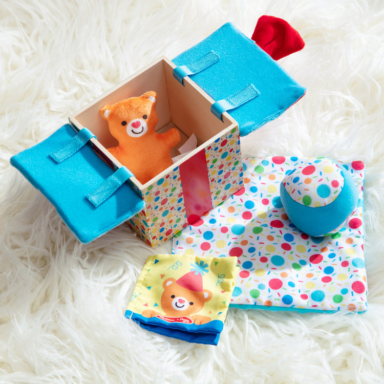 A playroom scene with The Melissa & Doug Wooden Surprise Gift Box Infant Toy (5 Pieces)
