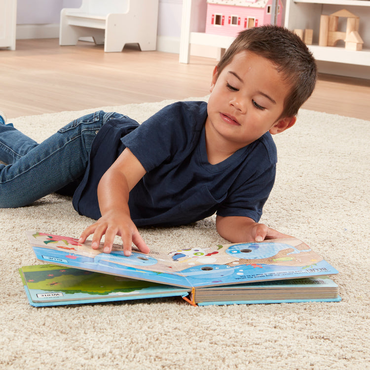 A kid playing with The Melissa & Doug Children's Book - Poke-a-Dot: What’s Your Favorite Color (Board Book with Buttons to Pop)