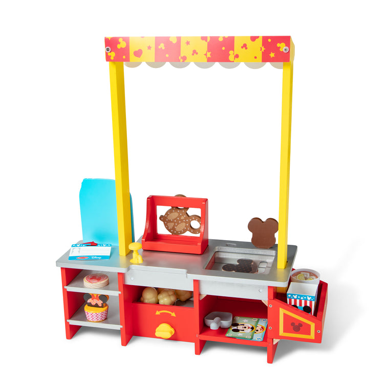 The loose pieces of The Melissa & Doug Disney Snacks & Popcorn Wooden Pretend Play Food Counter – 33 Pieces