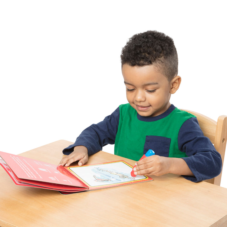 A child on white background with The Melissa & Doug On the Go Water Wow! Reusable Water-Reveal Coloring Activity Pad – Sports