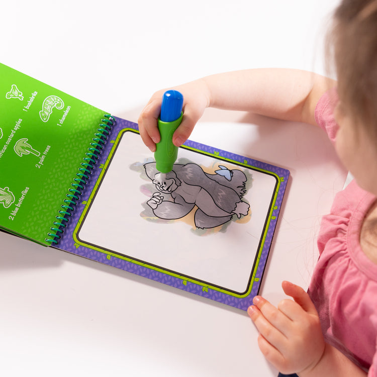 A kid playing with The Melissa & Doug On the Go Water Wow! Reusable Water-Reveal Coloring Activity Pad Travel Toy for Boys and Girls– Jungle