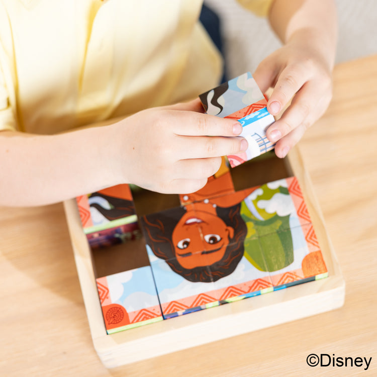 A kid playing with The Melissa & Doug Disney Princess Wooden Toy Cube Puzzle Blocks for Boys and for Girls 3+