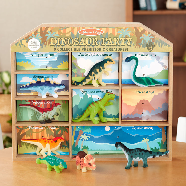 A playroom scene with The Melissa & Doug Dinosaur Party Play Set - 9 Collectible Miniature Dinosaurs in a Case