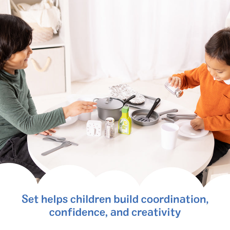 A kid playing with The Melissa & Doug 22-Piece Play Kitchen Accessories Set - Utensils, Pot, Pans, and More