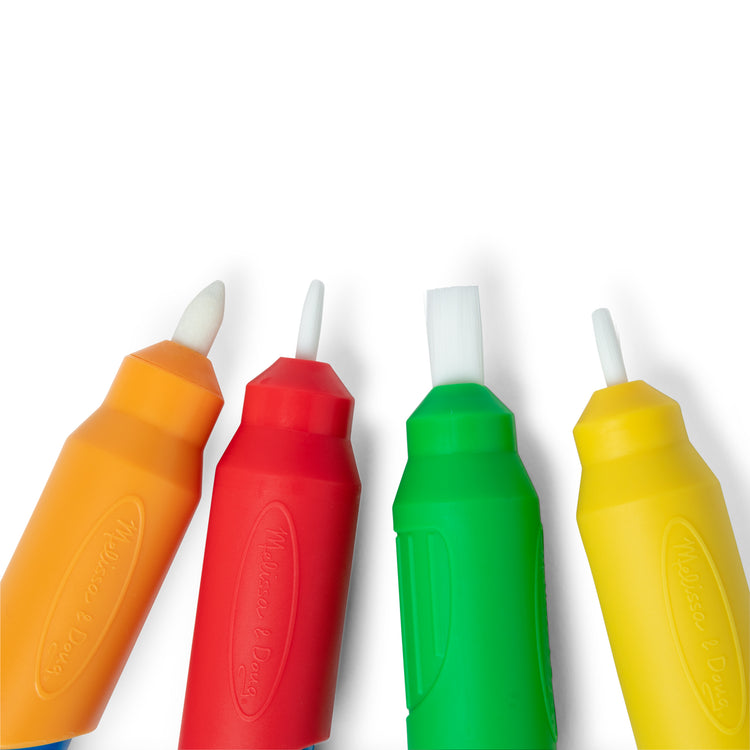 A kid playing with The Melissa & Doug Water WOW! Pen Pack - 4 Color-with-Water Pens, Sprayer, Tether Cap