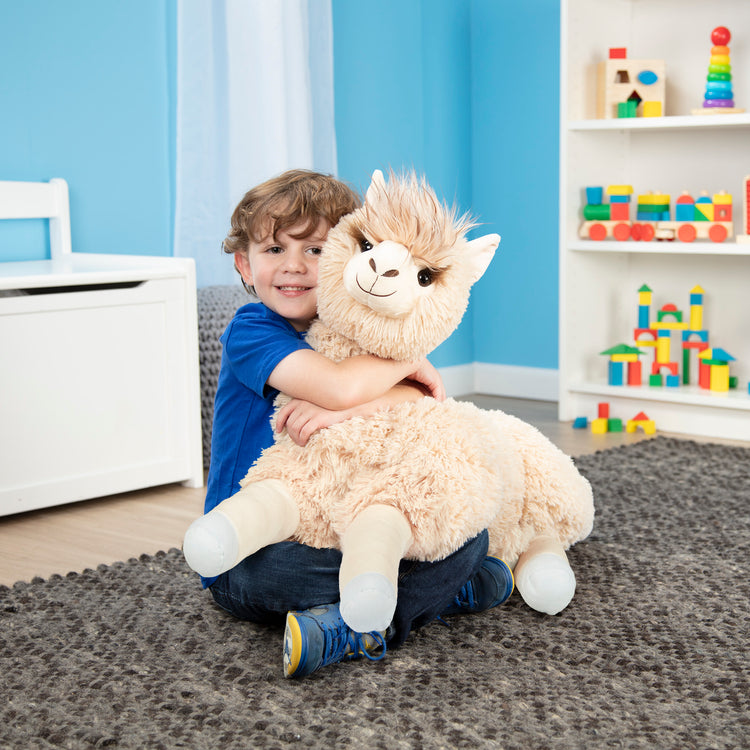 A kid playing with The Melissa & Doug Jumbo Llama Stuffed Plush Animal (26 Inches Tall)