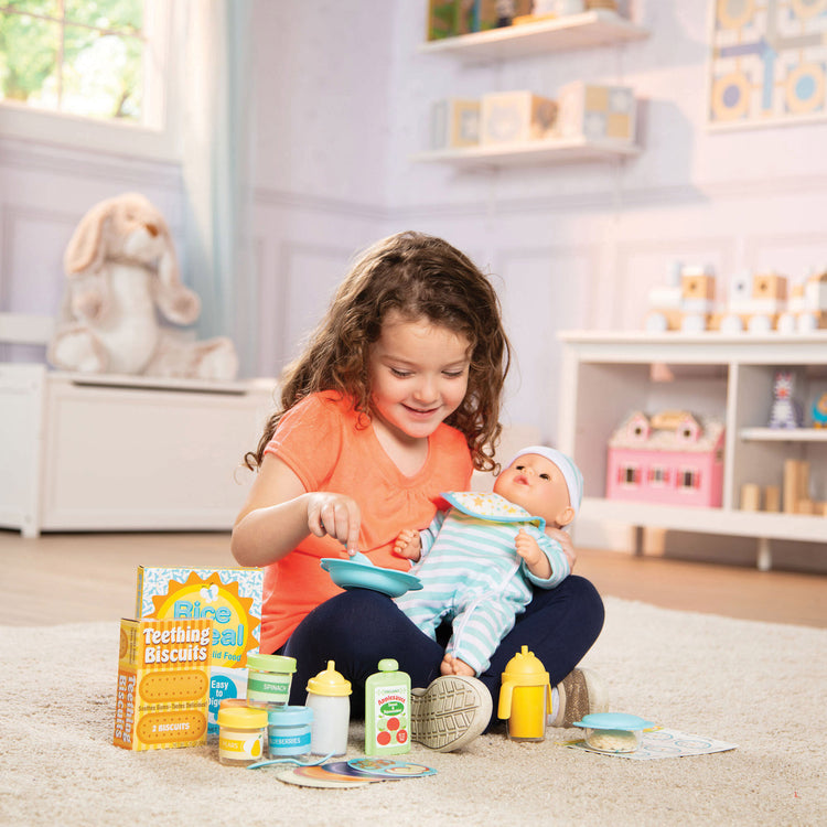 A kid playing with The Melissa & Doug Mine to Love Mealtime Play Set for Dolls with Bottle, Pretend Baby Food Jars, Snack Pouch, More (24 pcs)