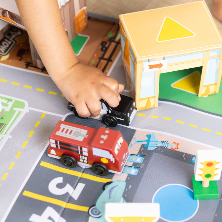 A kid playing with The Radiator Springs Nest and Stack Play Set