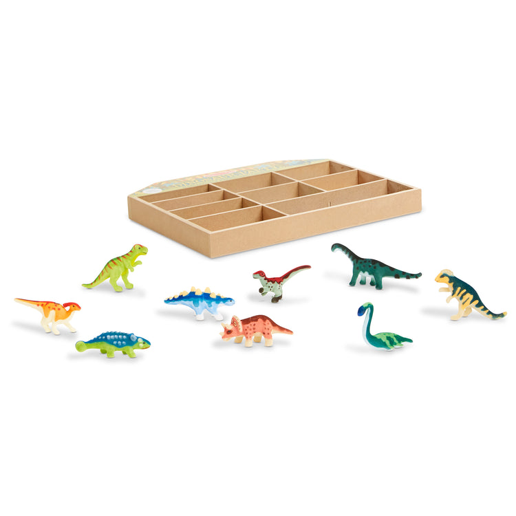 The loose pieces of The Melissa & Doug Dinosaur Party Play Set - 9 Collectible Miniature Dinosaurs in a Case