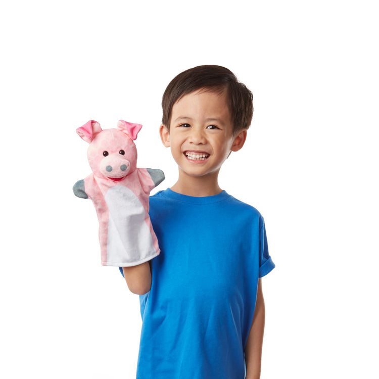 A child on white background with the Melissa & Doug Barn Buddies Hand Puppets, Set of 6 (Cow, Sheep, Horse, Duck, Chicken, Pig)