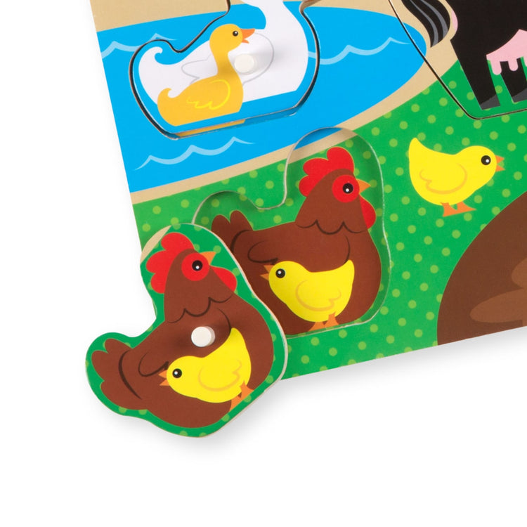 The loose pieces of the Melissa & Doug Farm Wooden Peg Puzzle (8 pcs)